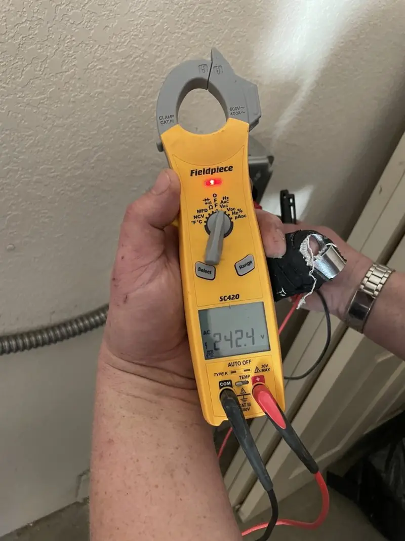 Voltage testing with clamp meter during Outlet Installation in Randolph